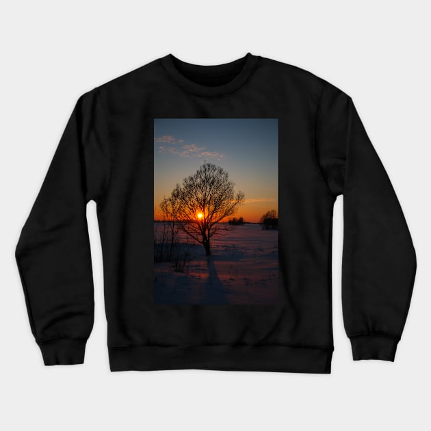 Sunset winter landscape with snow-covered road in violet and pink colors Crewneck Sweatshirt by Olga Berlet